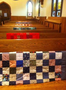 Lap Quilts hung over the pews for Veteran's Day.